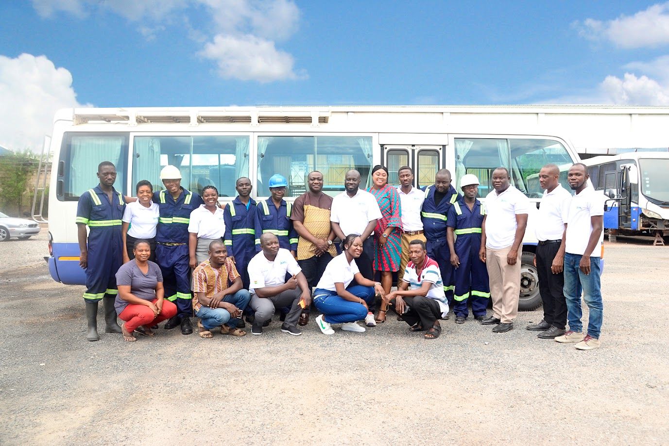 PTL team in front of a PTL staff bus at the PTL yard